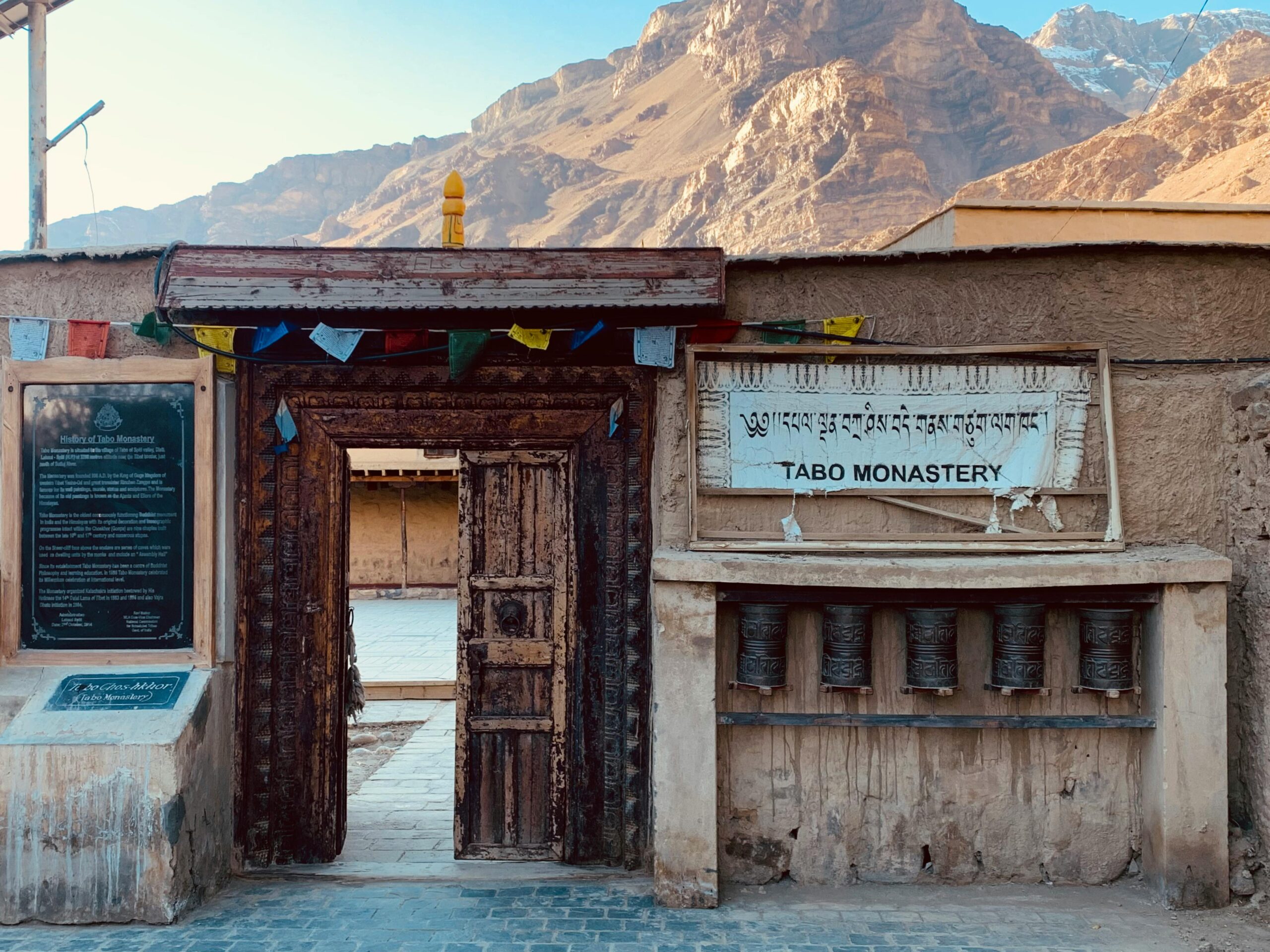 The ancient Tabo Monastery entrance set against the stunning Himalayan mountains.