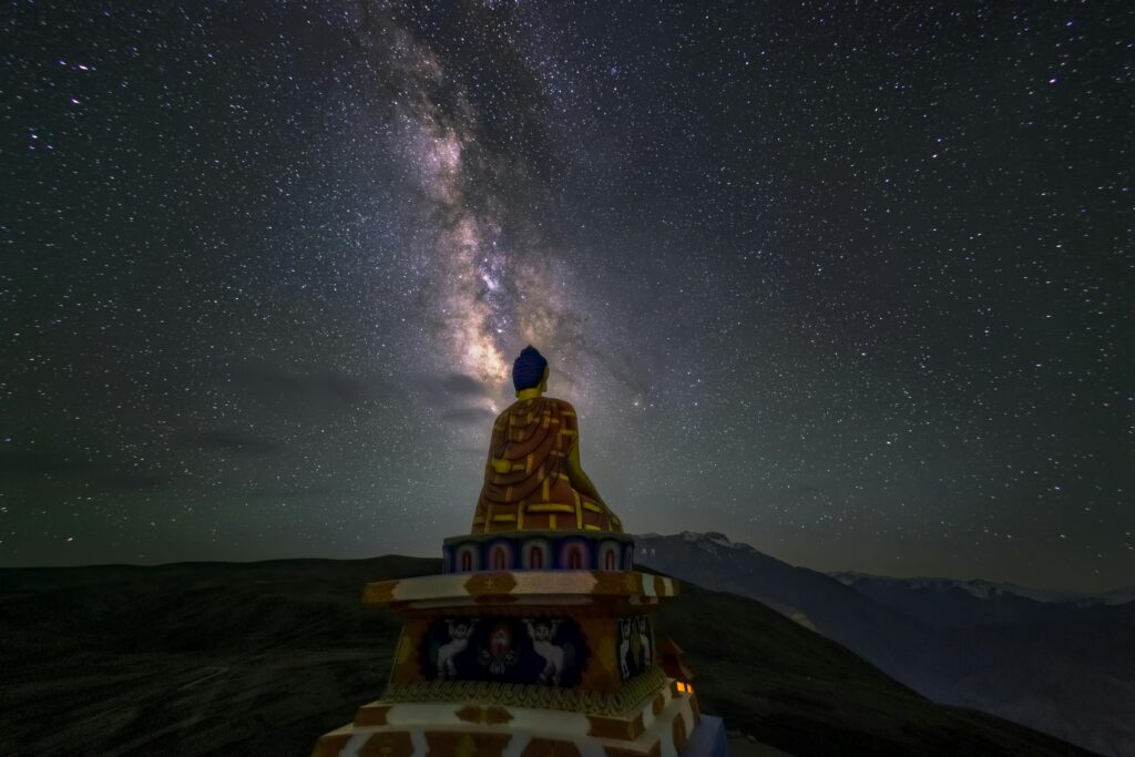 A mesmerizing long exposure shot of the Milky Way above a Buddha statue in Kaza, HP, India.